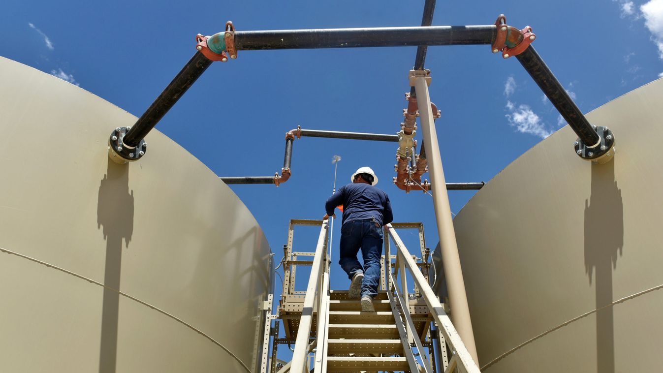 Lease Operator Jon Pearson inspects oil tanks at a production facility owned by Parsley Energy in the Permian Basin near Midland