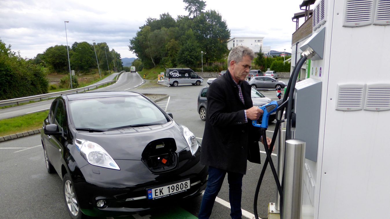 Nordboe recharges his Nissan Leaf electric car in Finnoey