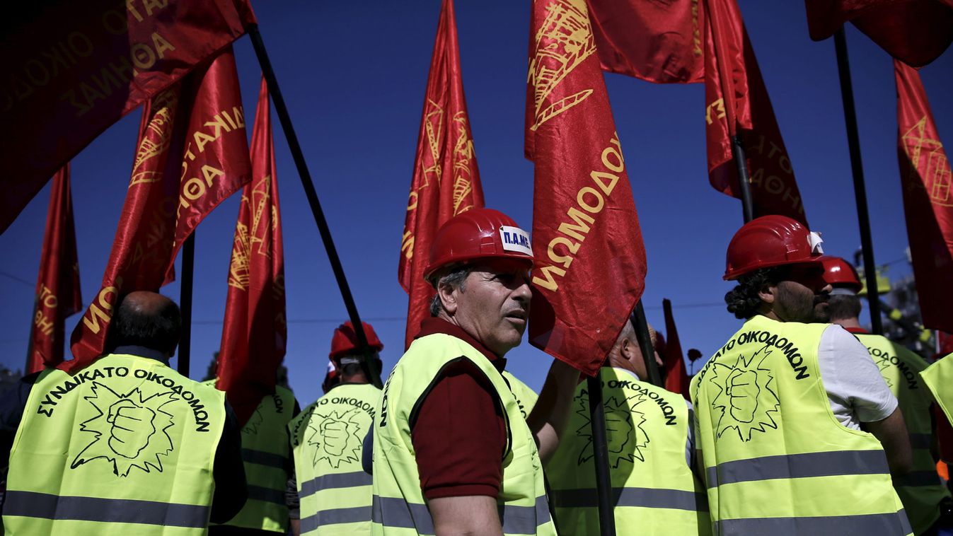 Protesters from the Communist-affiliated trade union PAME hold red flags during a May Day rally in Athens 