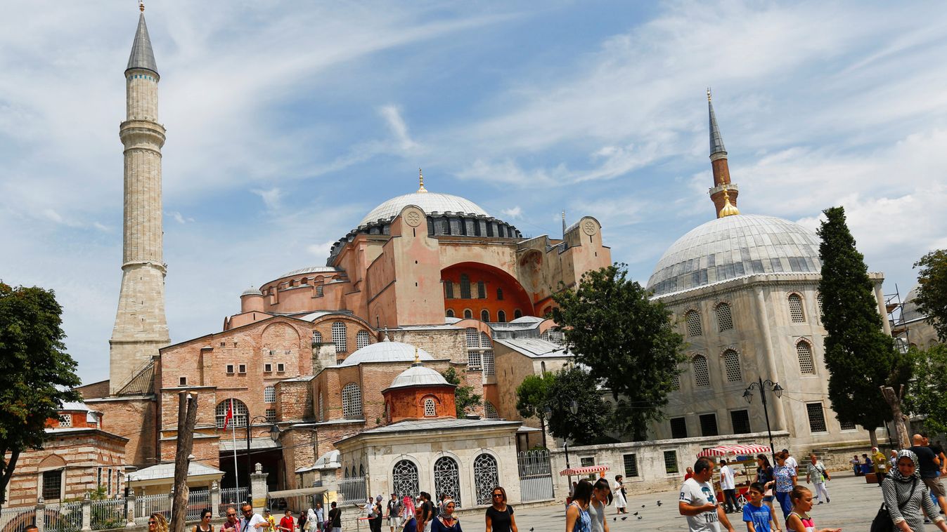 Tourists walk as they leave the Byzantine-era monument of Hagia Sophia or Ayasofya, now a museum, in Istanbul
