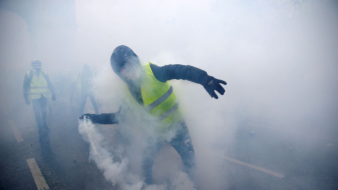 A protester wearing a yellow vest, a symbol of a French drivers' protest against higher diesel taxes, demonstrates near the Place de l'Etoile in Paris