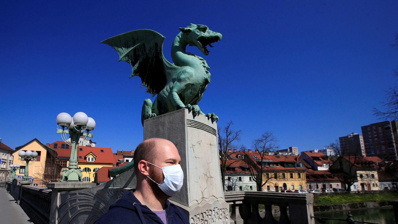 A man with a face mask walks on the Dragon's bridge during coronavirus disease (COVID-19) fears, in Ljubljana