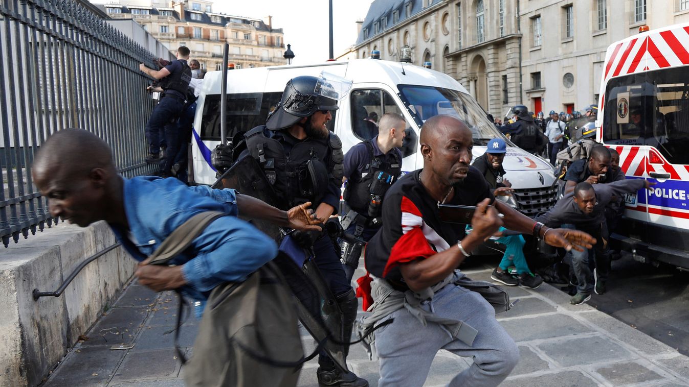 Riot police officers clash with undocumented migrants outside the Pantheon in Paris