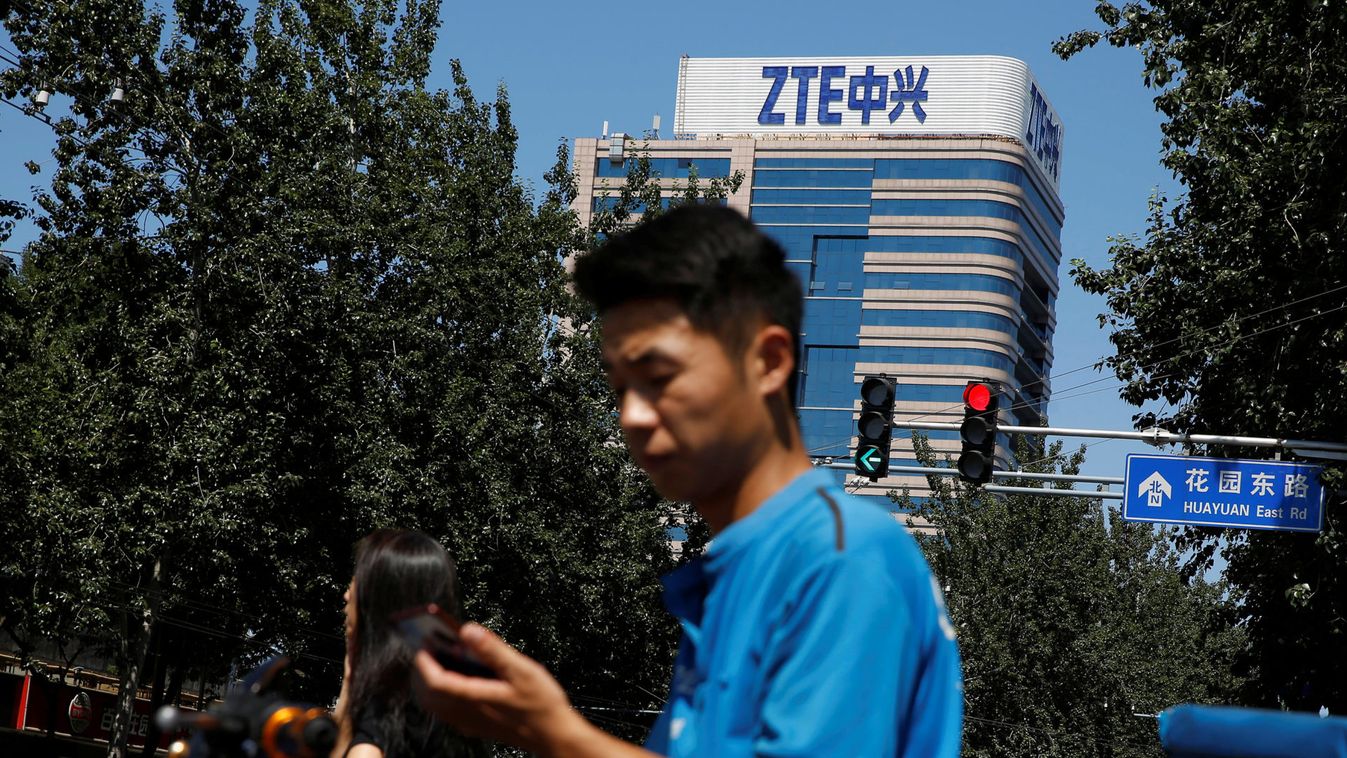 A delivery man uses a phone near a building of China's ZTE Corp in Beijing