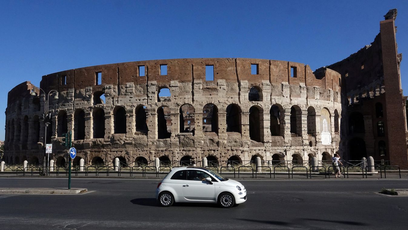 A Fiat 500 is seen in front of the ancient Colosseum in Rome