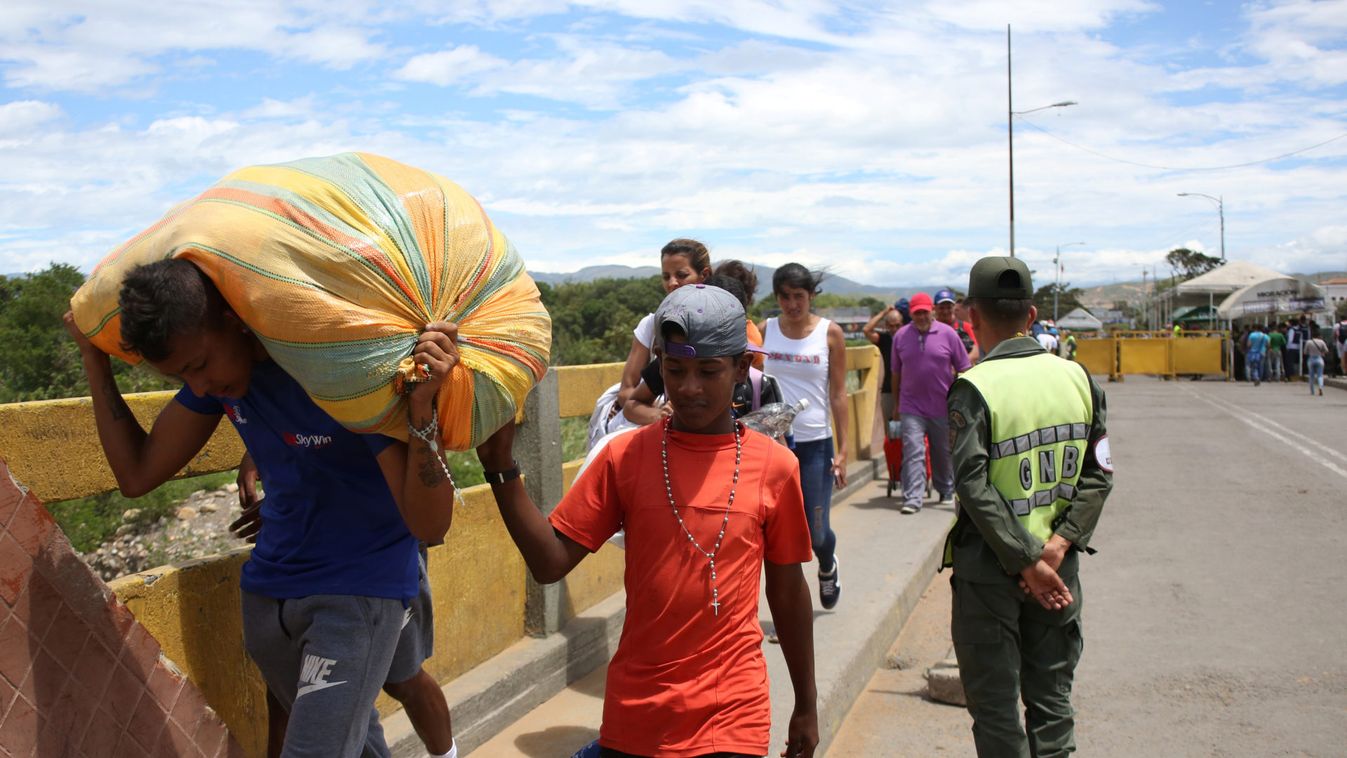 People cross the Colombian-Venezuelan border over the partially opened Simon Bolivar international bridge in San Antonio del Tachira