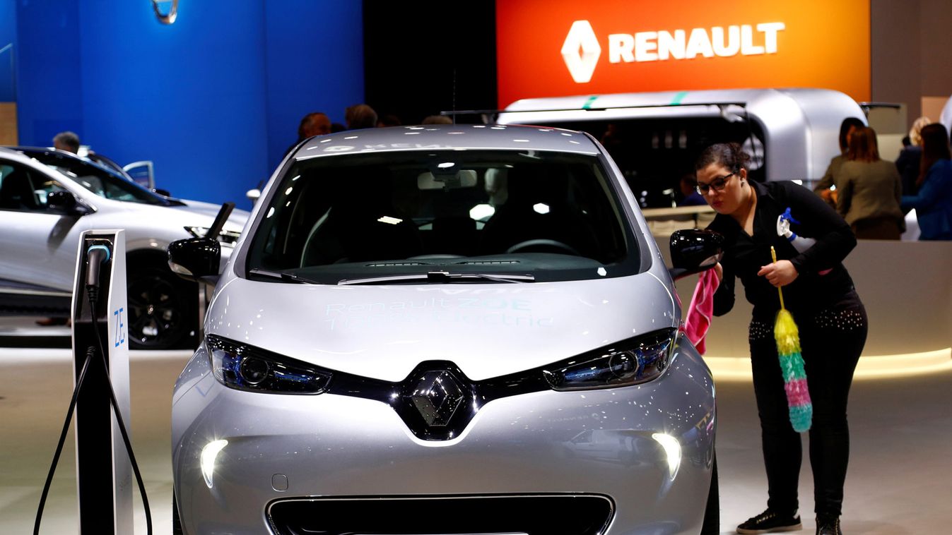 A worker cleans a Renault Zoe electric car at Brussels Motor Show