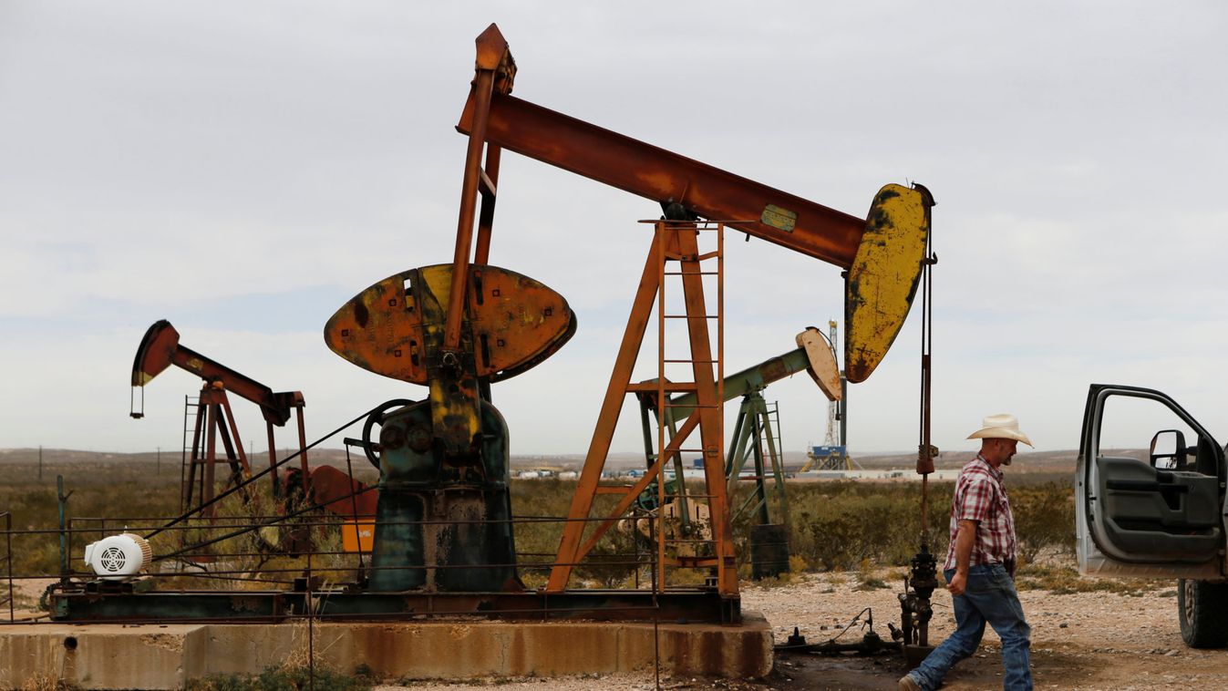 Paul Putnam, 53, a rancher and independent contract pumper walks past a pump jack in Loving County