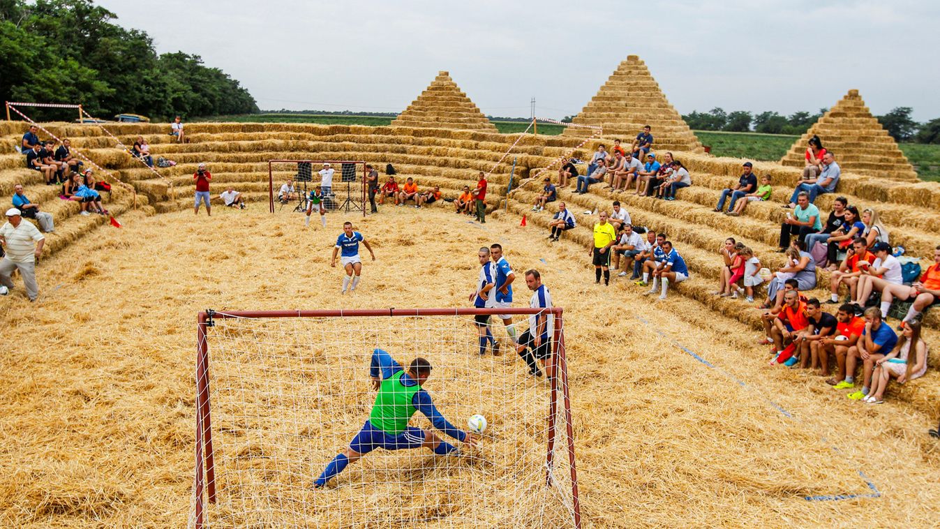 Players attend a football tournament among local amateur teams at a stadium made of straw named Zenit Arena, in the settlement of Krasnoye in Stavropol region