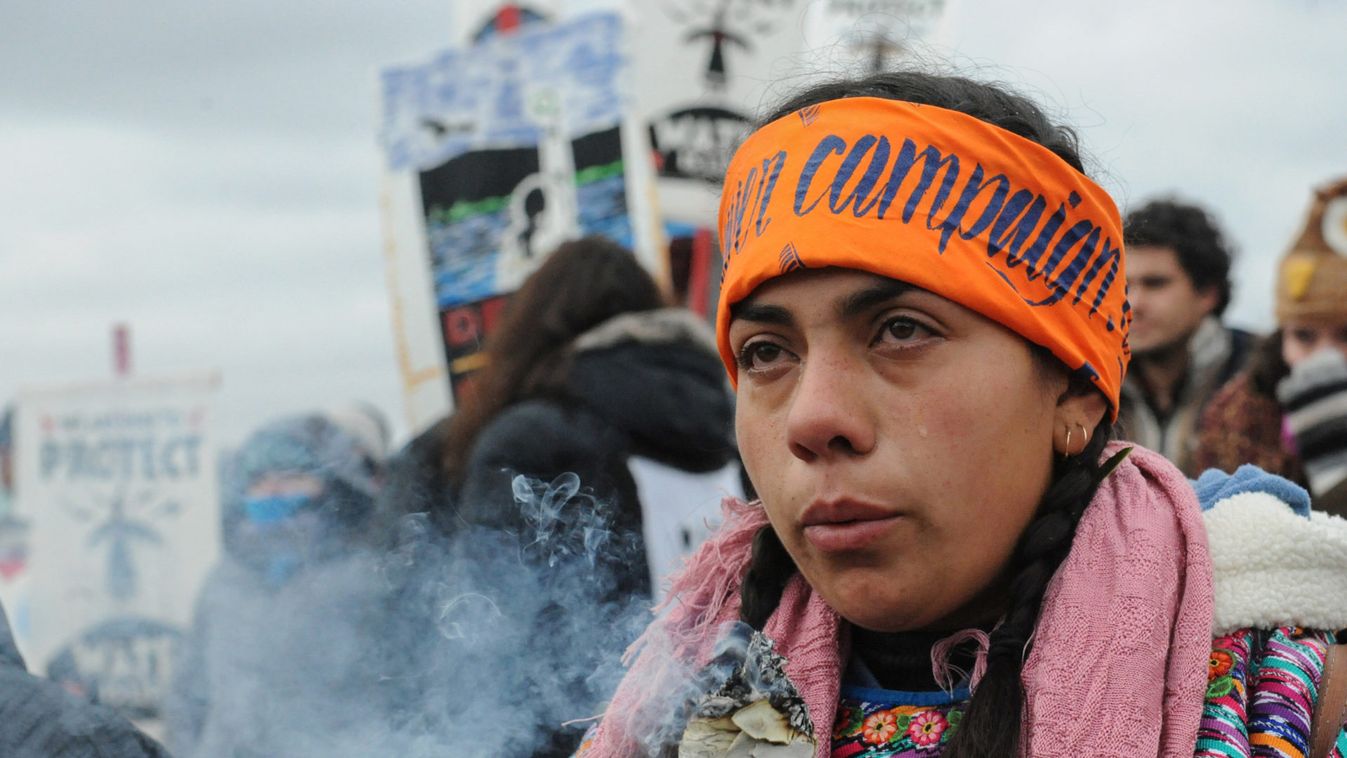 A protester cries while watching a demonstration on Turtle Island on Thanksgiving day during a protest against plans to pass the Dakota Access pipeline near the Standing Rock Indian Reservation, near Cannon Ball, North Dakota, U.S.