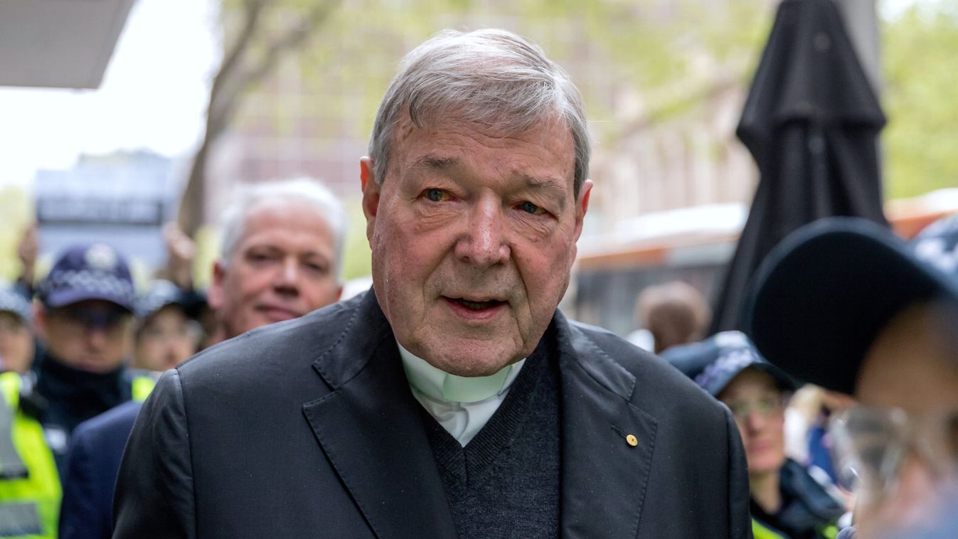 Vatican Treasurer Cardinal George Pell is surrounded by Australian police as he leaves the Melbourne Magistrates Court in Australia
