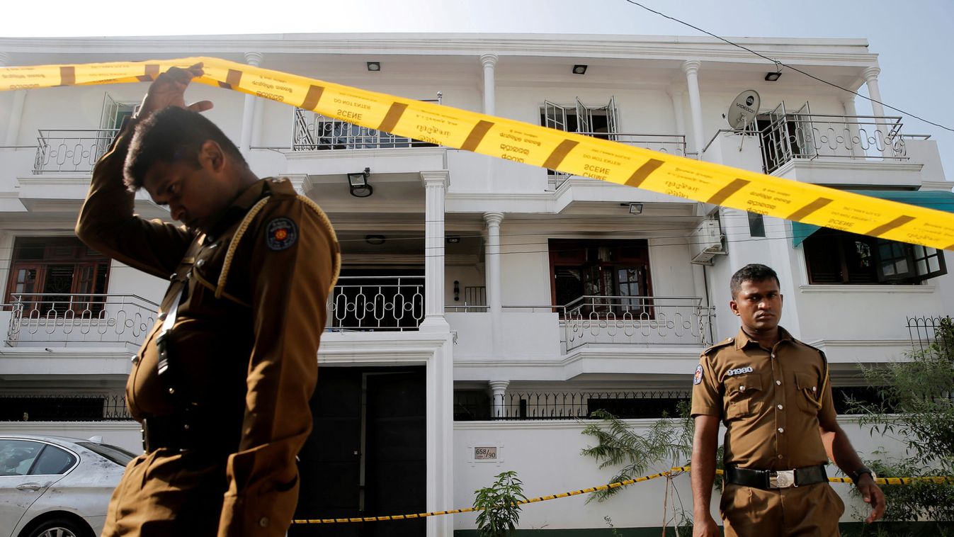 Police keep watch outside the family home of a bomber suspect where an explosion occurred during a Special Task Force raid in Colombo