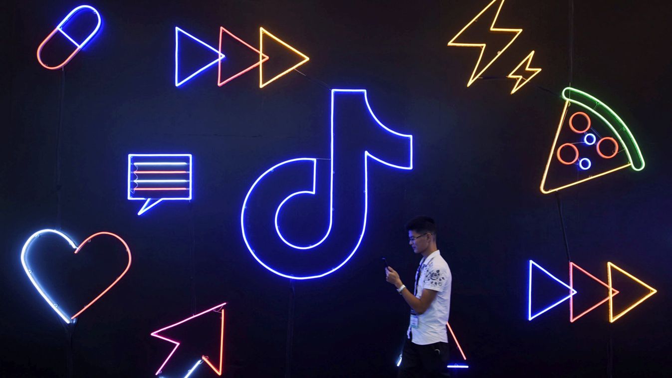 Man walks past a sign of ByteDance's app TikTok, known locally as Douyin, at an expo in Hangzhou