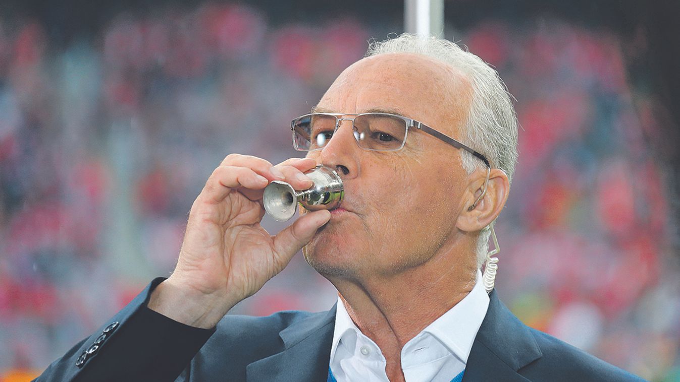 Former German international and Bayern Munich soccer player Beckenbauer drinks schnaps before the German first division Bundesliga soccer match between Bayern Munich and Augsburg in Munich