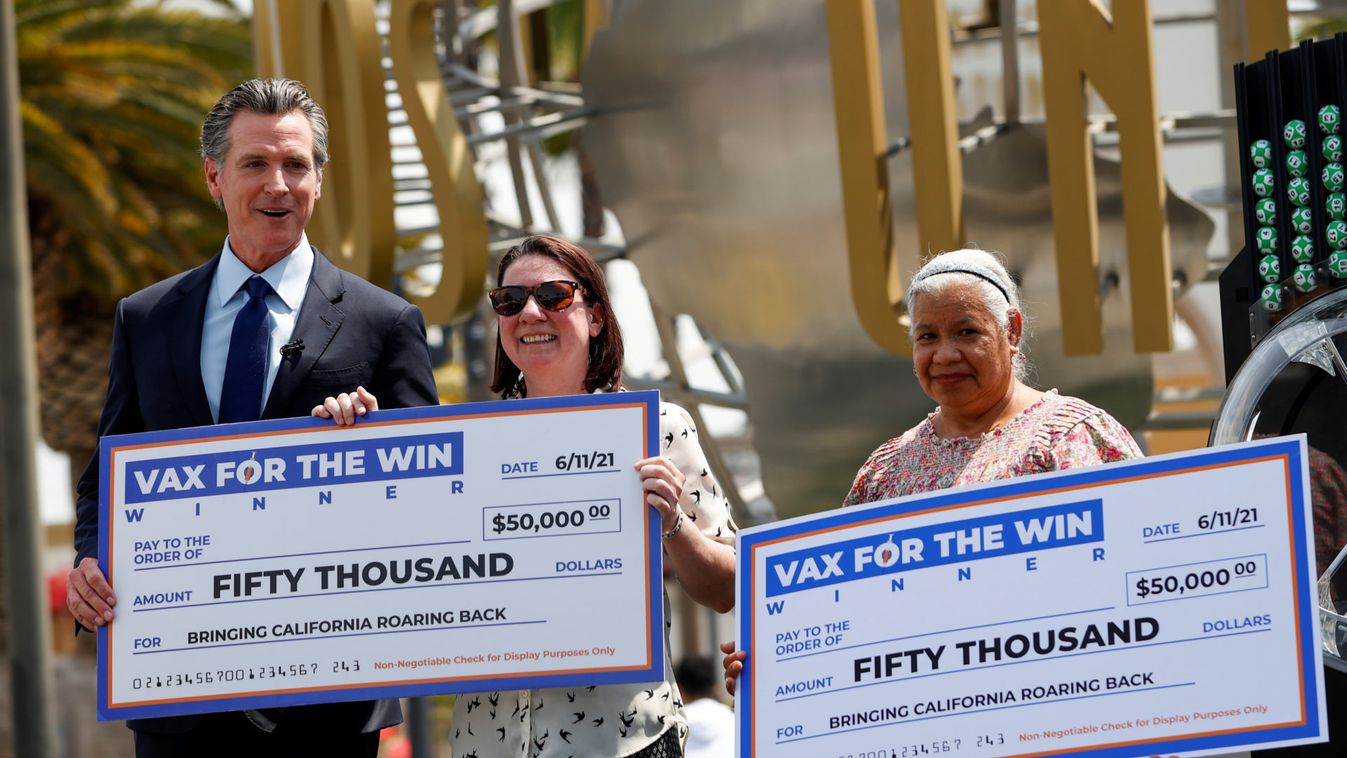 California Governor Newsom poses with two of the winners of the Vax for the Win lottery contest program, at Universal Studios Hollywood