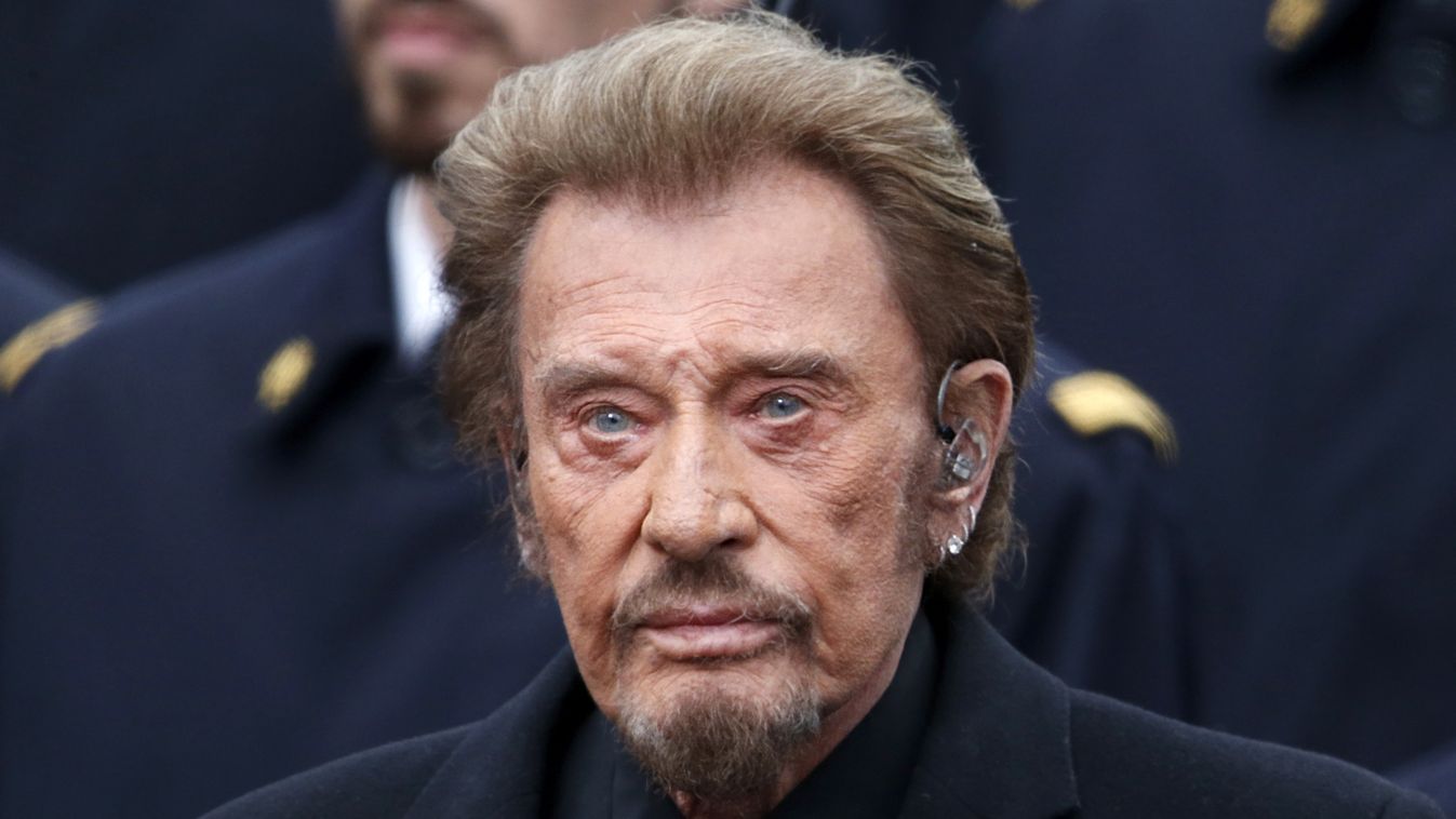French singer Johnny Hallyday attends a ceremony at Place de la Republique square to pay tribute to the victims of last year's shooting at the French satirical newspaper Charlie Hebdo, in Paris