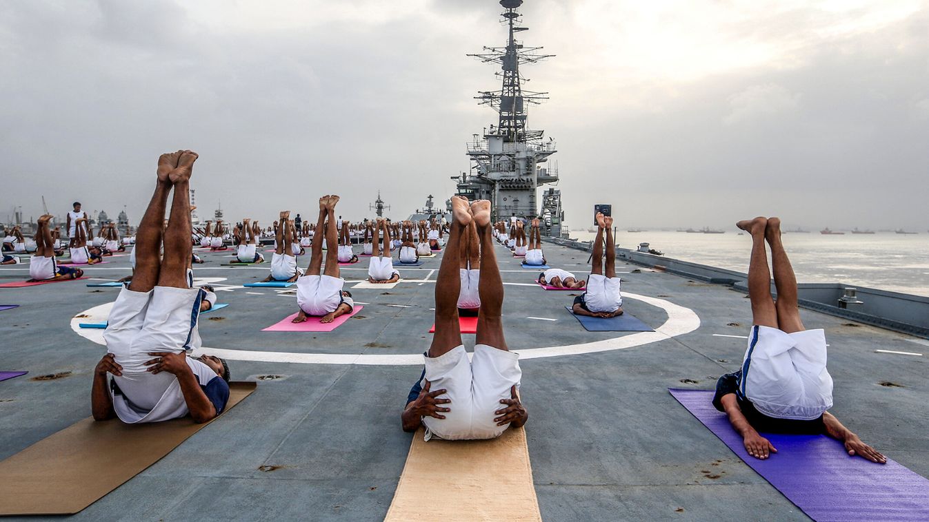 Members of the Indian Navy perform yoga on the flight deck of INS Viraat during International Yoga Day in Mumbai