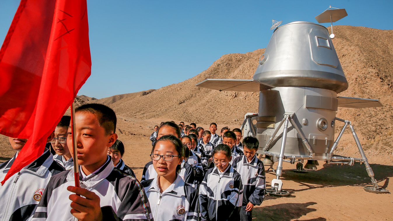 Students leave a mock space capsule after a lesson at the C-Space Project Mars simulation base in the Gobi Desert outside Jinchang