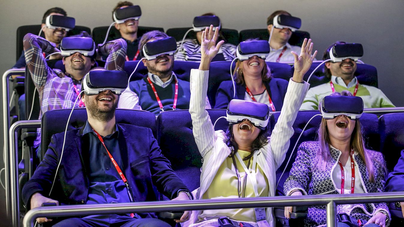 People test Samsung Gear VR glasses at their stand during the Mobile World Congress in Barcelona