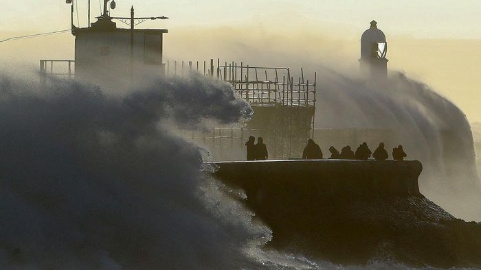 Waves crash against the sea wall at Porthcawl, south Wales, on February 18, 2022 as Storm Eunice brings high winds across the country. - Britain put the army on standby Friday and schools closed as forecasters issued two rare "red weather" warnings of "danger to life" from fearsome winds and flooding due to the approaching storm Eunice. (Photo by Geoff Caddick / AFP)