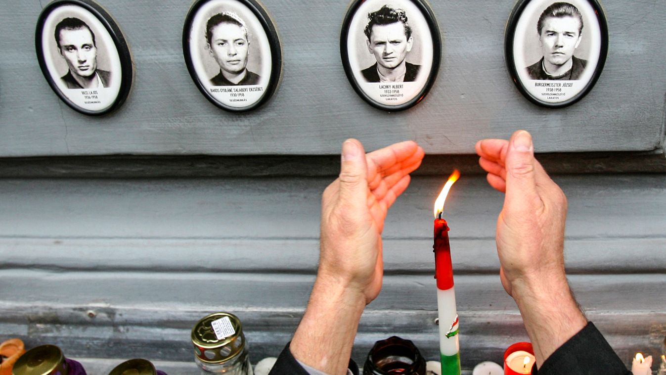 A man lights a candle in front of the Museum of Terror to commemorate victims of the communist regime in Budapest