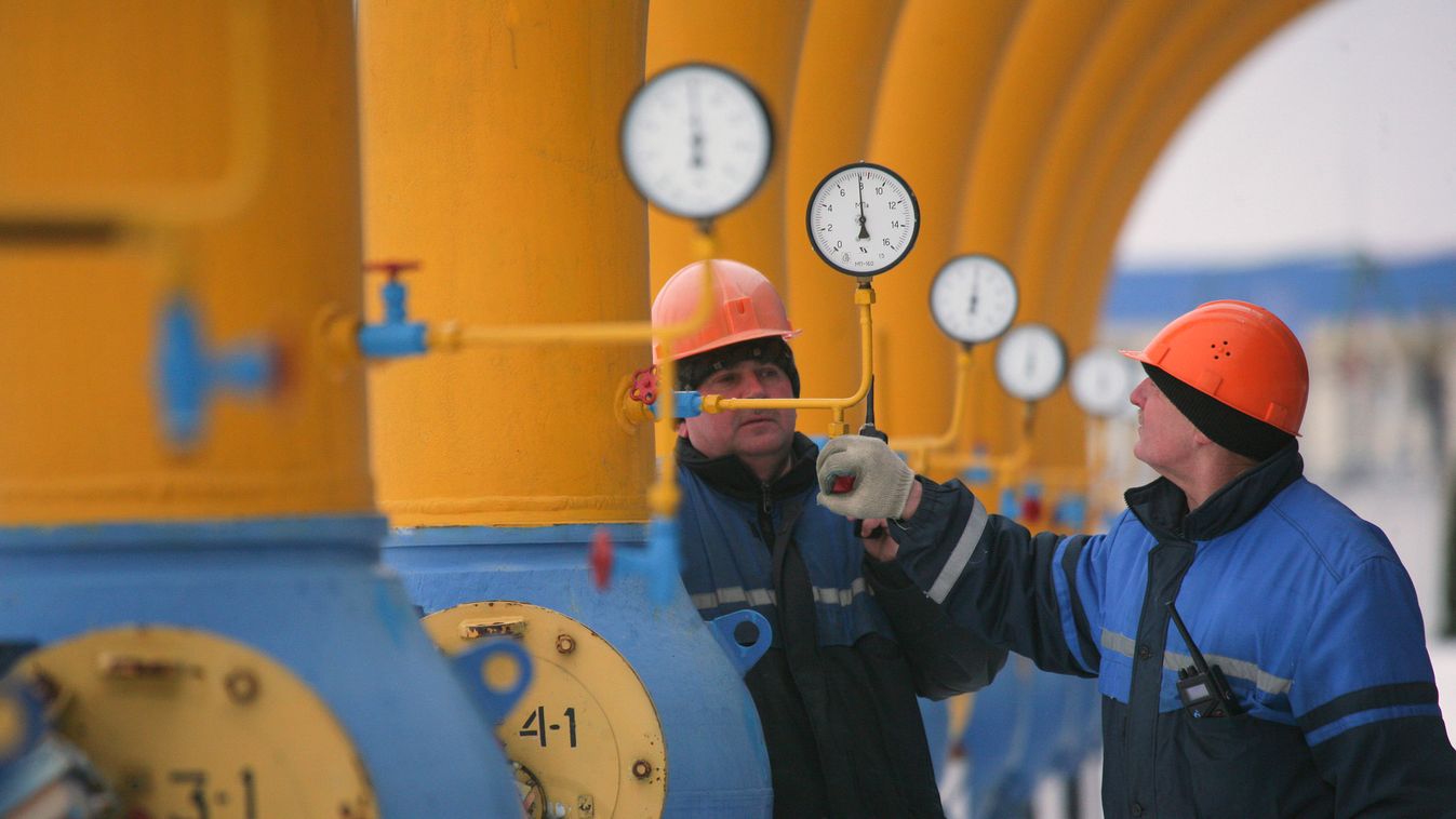 Workers check the pressure at the Nesvizhskaya gas compressor station near Minsk