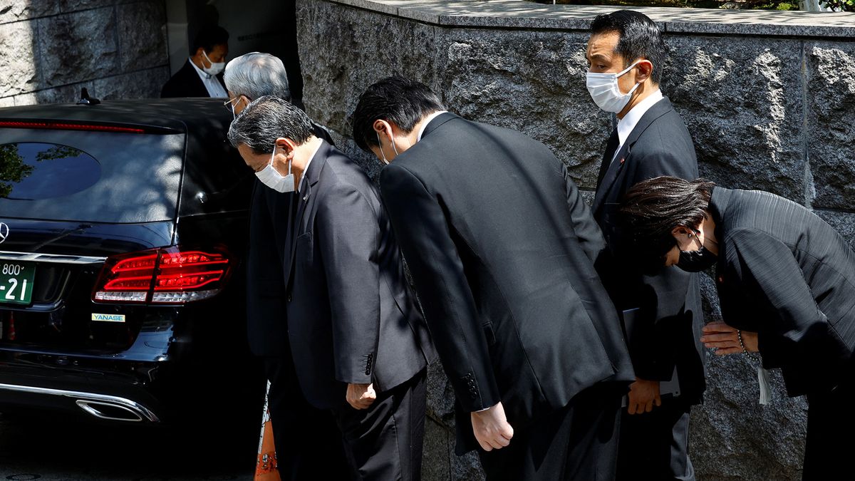 Japanese lawmaker Sanae Takaichi prays to the vehicle believed to be carrying the body of former Japanese Prime Minister Shinzo Abe, who was shot while campaigning for a parliamentary election, at his residence in Tokyo