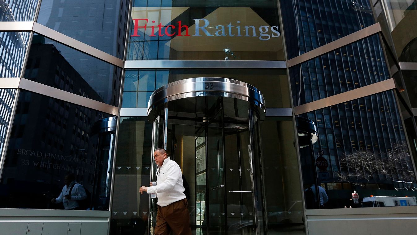 People walk past the headquarters of Fitch Ratings in New York