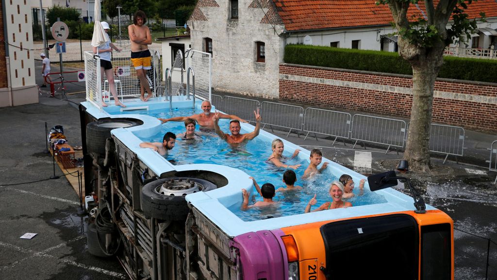People bathe in a decommissioned city bus named "le bus piscine", an artwork by the French artist Benedetto Bufalino in Gosnay near Bethune