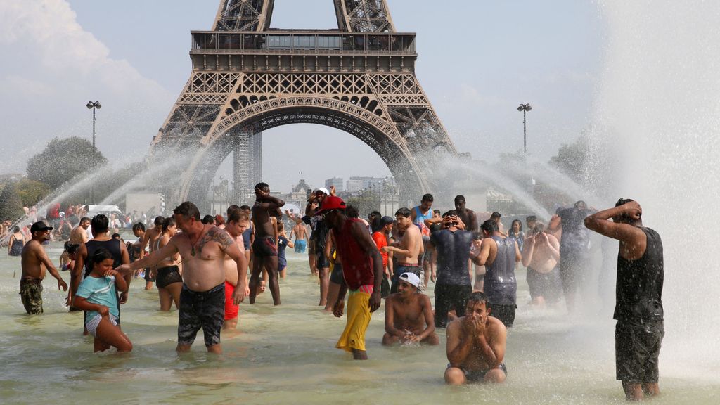 People cool off in the Trocadero fountains across from the Eiffel Tower in Paris