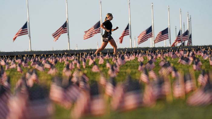 American flags representing 200,000 lives lost due to coronavirus are placed on National Mall in Washington