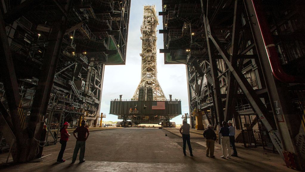 NASA employees look on as the Artemis launch tower rolls back from Pad 39B inside Bay 3 of the Vehicle Assembly Building at the Kennedy Space Center before Hurricane Dorian makes landfall