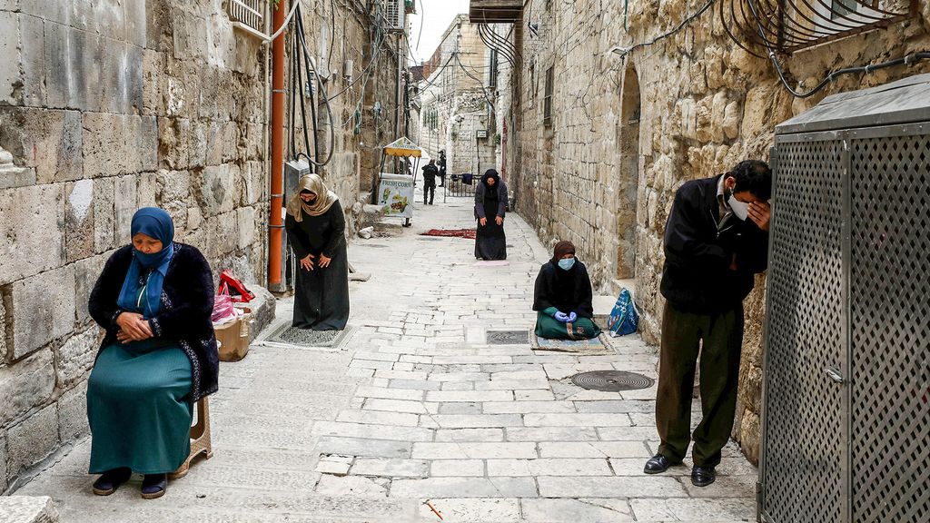 Muslims pray during the first Friday prayer of Ramadan in an alley in Jerusalem's Old City amid the coronavirus disease (COVID-19) restrictions