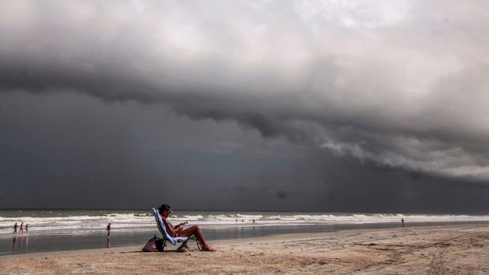 Tricia Cheshire, a resident of Amelia Island sunbathes for the last few minutes before storms hit the coast before Hurricane Dorian in Jacksonville, Florida