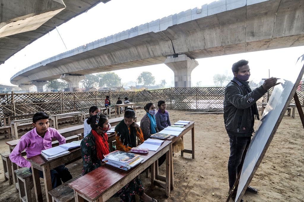 India: Children attend a school under the bridge in New Delhi