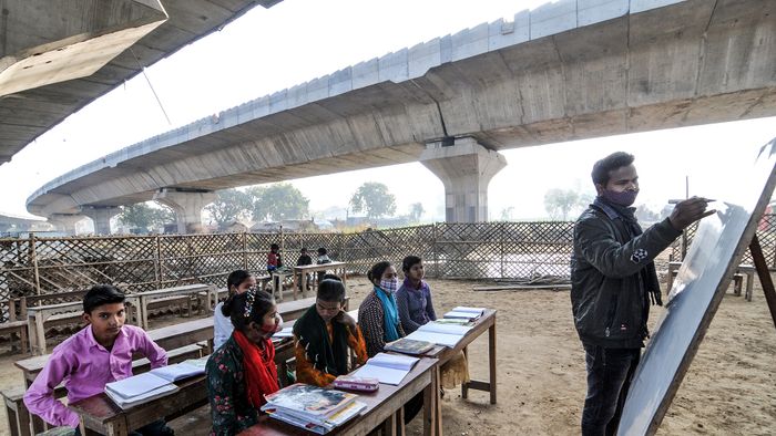 India: Children attend a school under the bridge in New Delhi