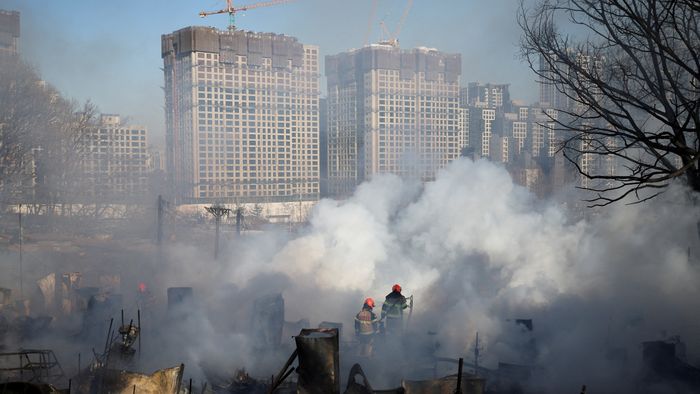 Firefighters work at the scene of a fire at Guryong village, in Seoul