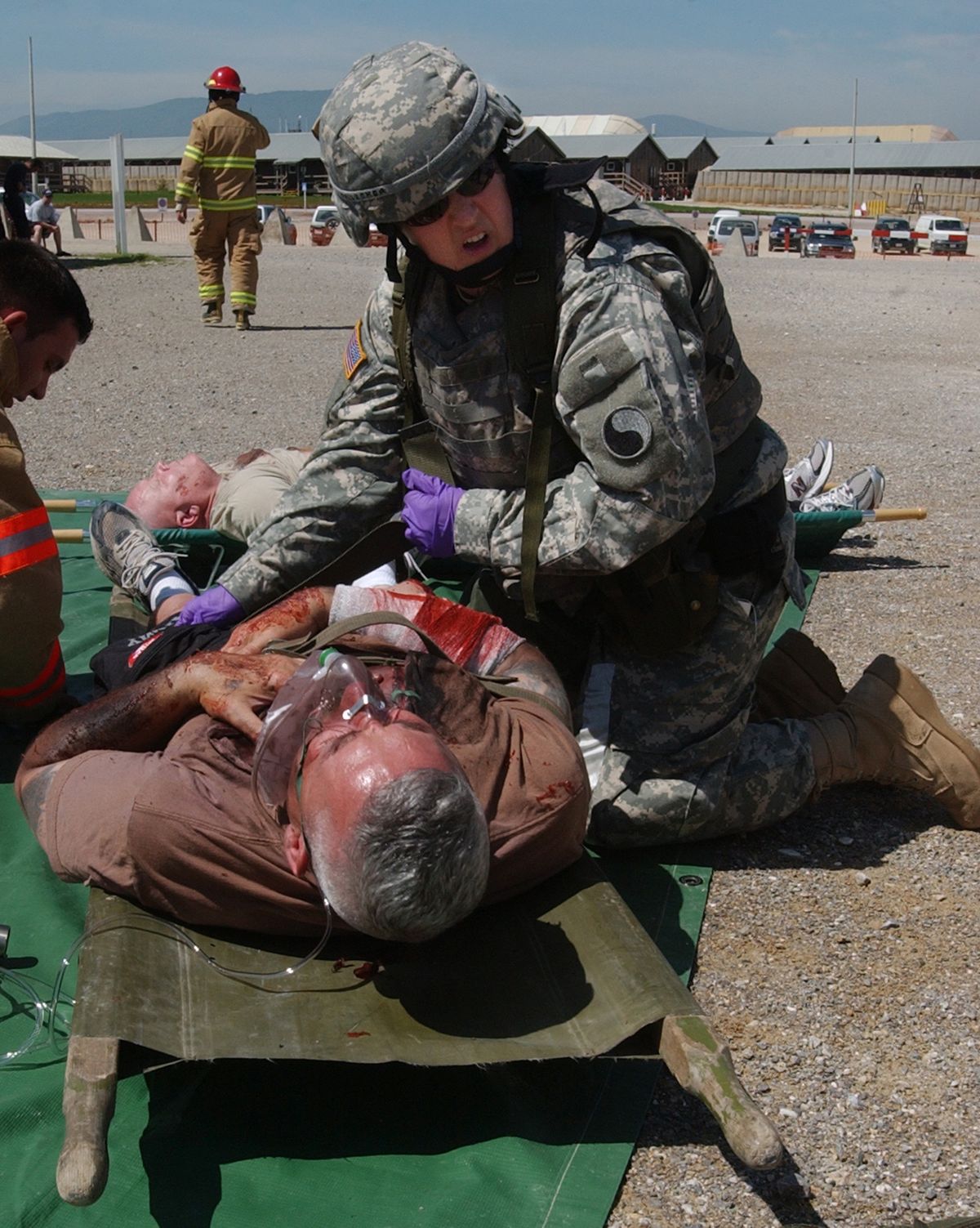 Sgt. Carolyn Gallagher, a reservist attached to the 29th infantry Division, yells for help during a mass casualty exercise at Camp Bondsteel, Kosovo May 9. The exercise tested Soldiers’ and Kellogg Brown and Root (KBR) fire fighters’ ability to react to an attack against the base.                            