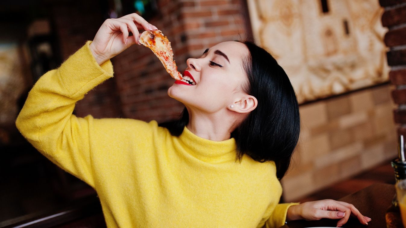 Funny,Brunette,Girl,In,Yellow,Sweater,Eating,Pizza,At,Restaurant.
kaja