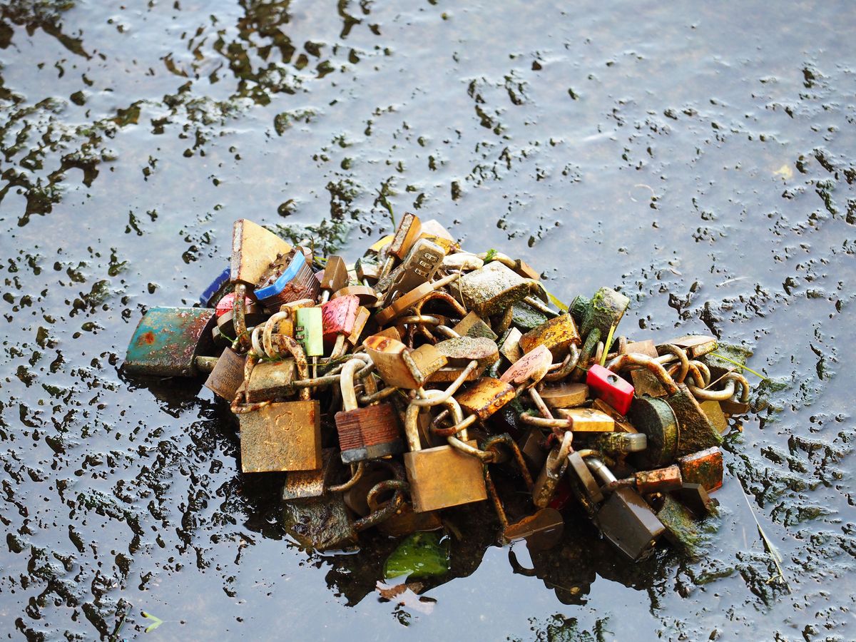 Famous bridge Pont des Arts on Seine river, Paris, France. Many cut locks in the water of the Seine river