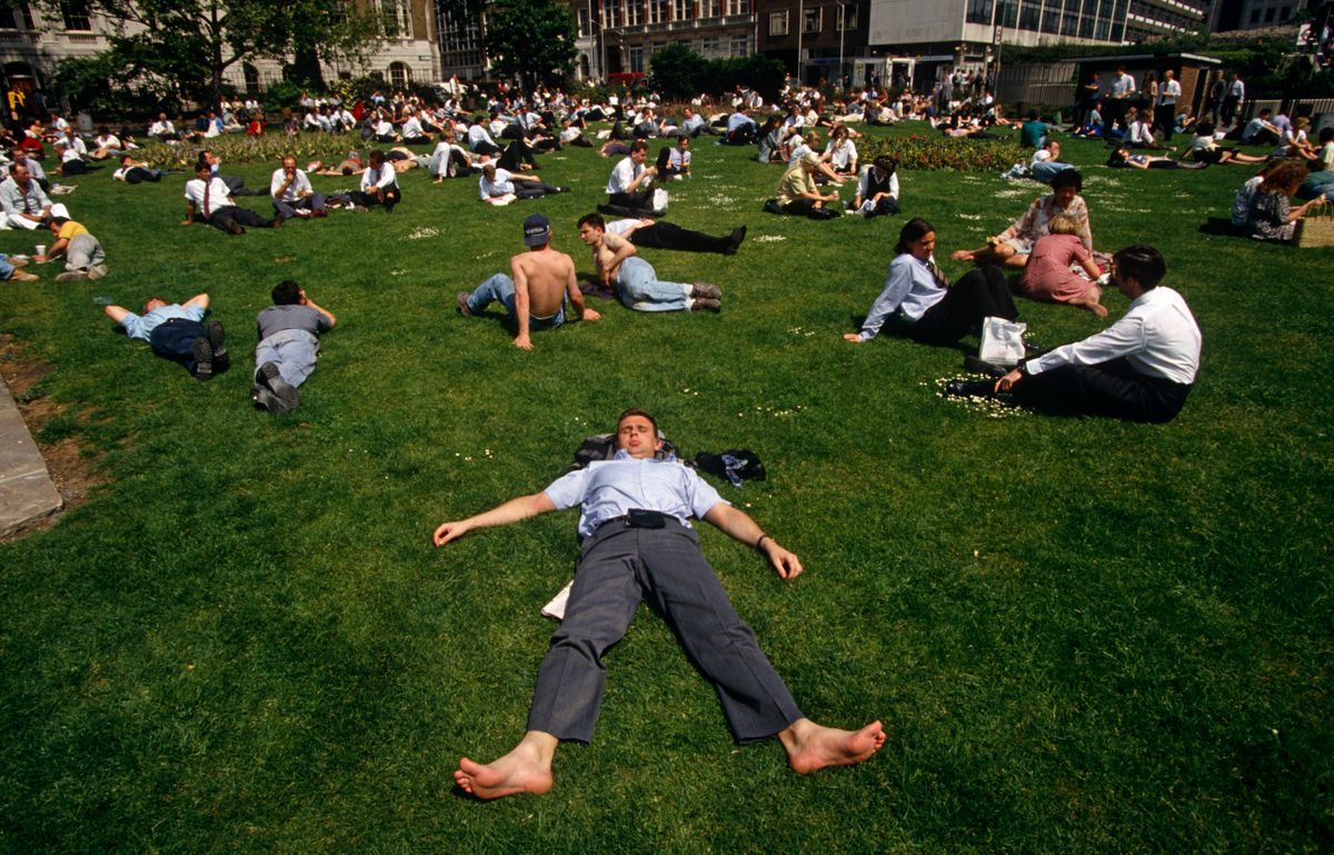 England - London - City office worker sunbathe during hot lunchtime