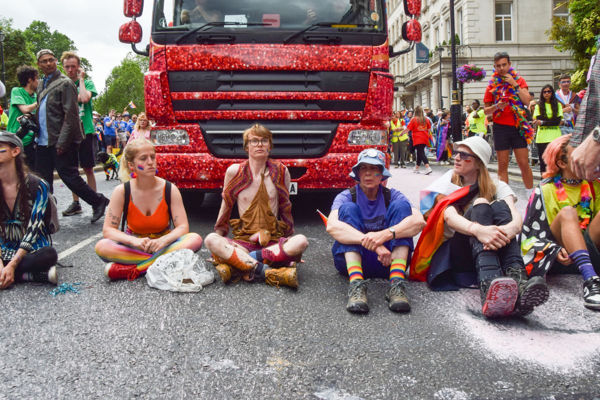 Protesters sit and block the road during the demonstration