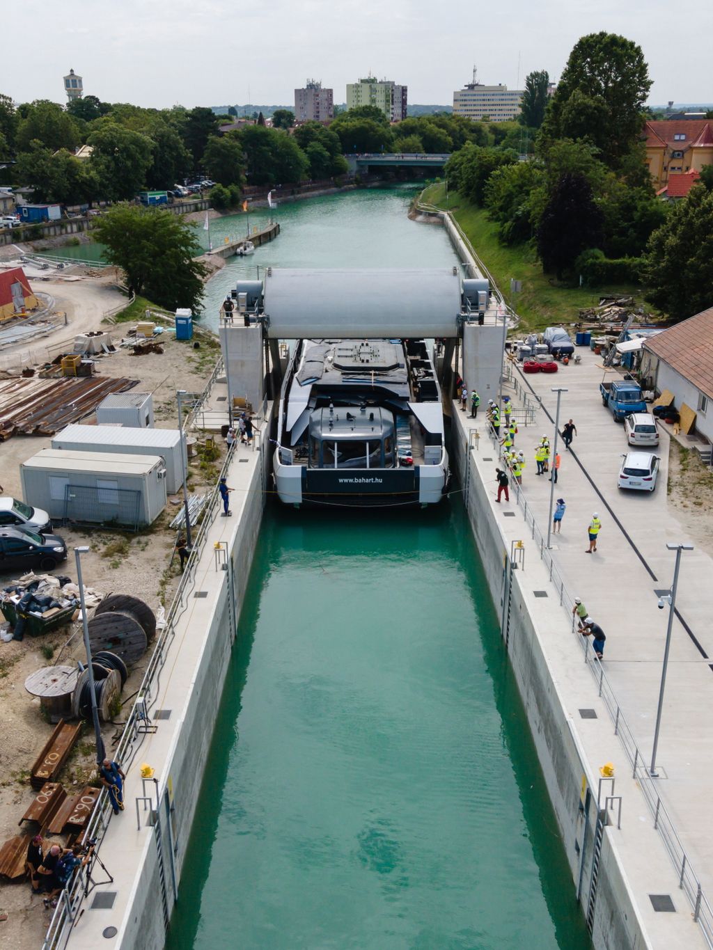 Siófok, 2023. július 3.
A drónnal készült felvételen a Balatoni Hajózási Zrt. (Bahart) egyik új kompját vontatják a Sió-csatornán siófoki hajózsiliphez 2023. július 3-án. A Bahart a Magyar Turisztikai Ügynökség (MTÜ) közreműködésével építtetett két új személyhajója és két kompja 2021-ben készült el a komáromi hajógyárban, ahonnan június 21-én indultak útnak, hogy a Dunán lehajózva a Sió-csatornán keresztül elérjék a Balatont.
MTI/Vasvári Tamás