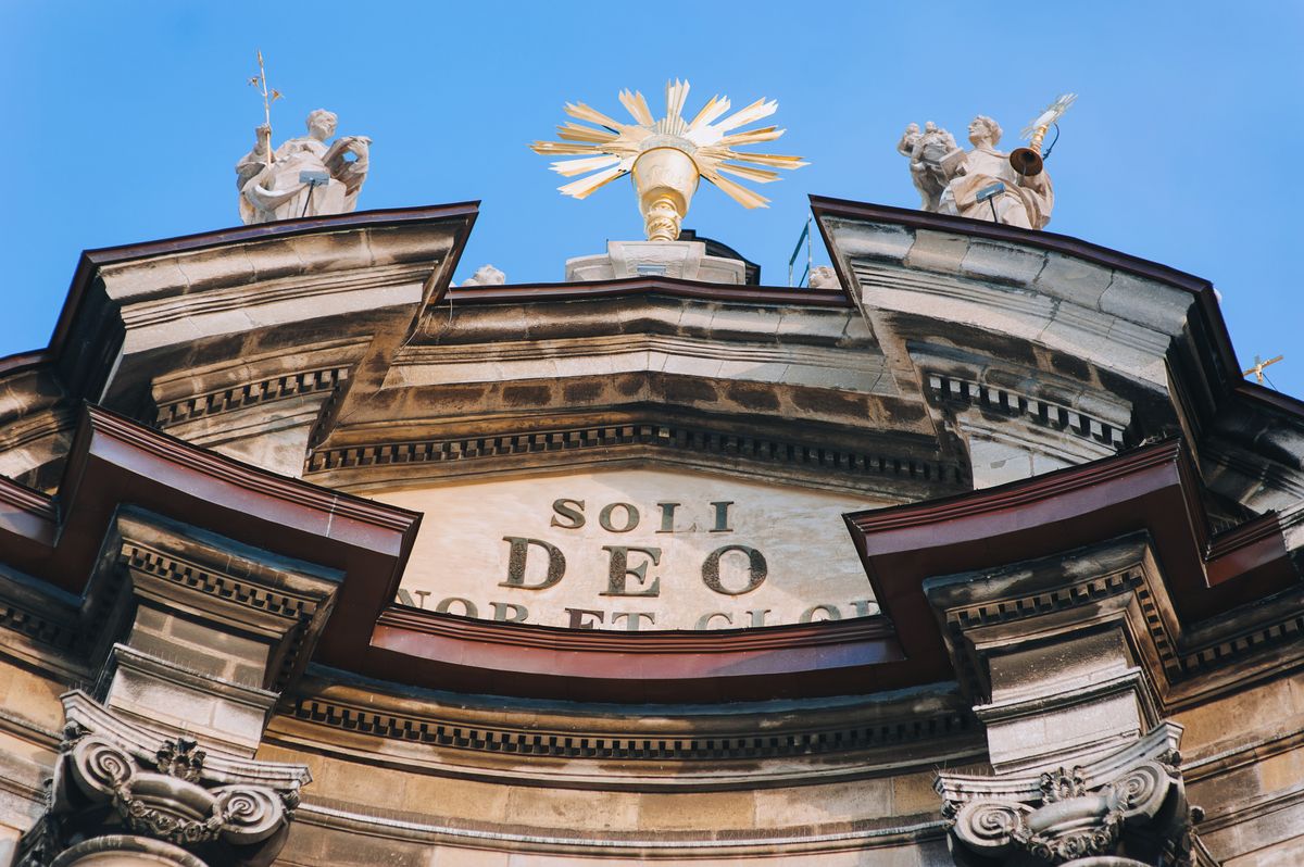 Close-up fragment of the Dominican Cathedral in Lviv, Ukraine. The inscription in Latin Soli Deo Honor et Gloria translated - Only to God is honor and glory.