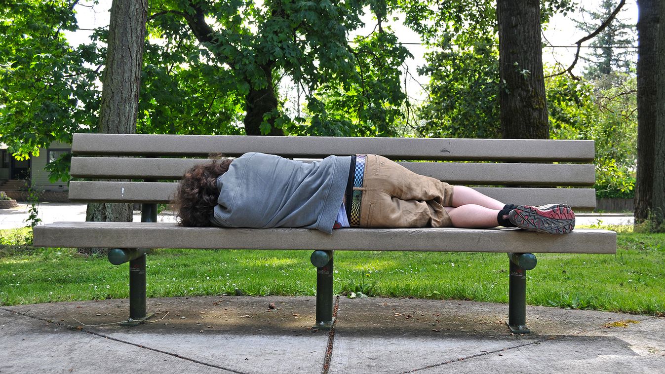 A,Homeless,Person,Takes,A,Nap,On,A,Bench,In