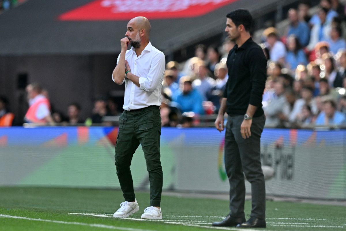 Manchester City's Spanish manager Pep Guardiola (L) and Arsenal's Spanish manager Mikel Arteta (R) look on during the English FA Community Shield football match between Arsenal and Manchester City at Wembley Stadium, in London, August 6, 2023. (Photo by Glyn KIRK / AFP) / NOT FOR MARKETING OR ADVERTISING USE / RESTRICTED TO EDITORIAL USE