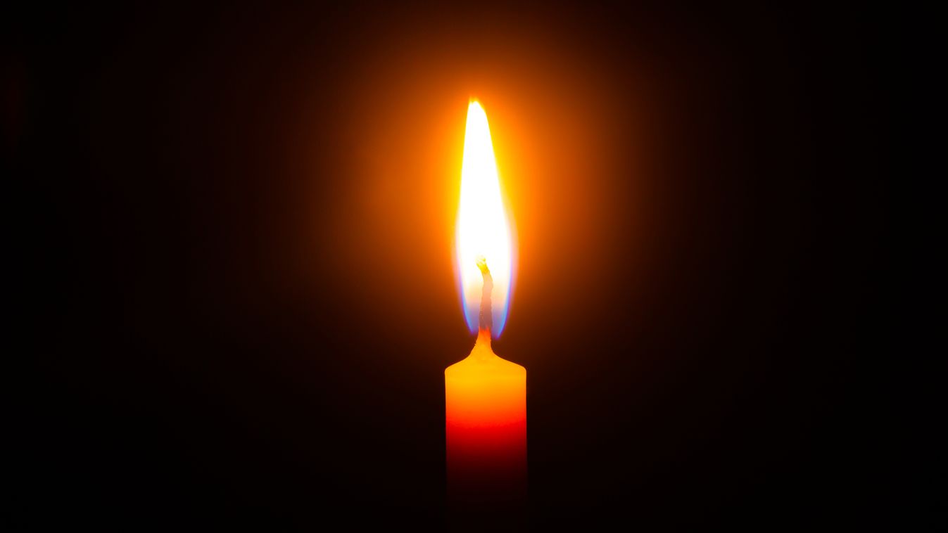 Close,Up,Single,Candle,Light,And,Flame,On,Black,Background