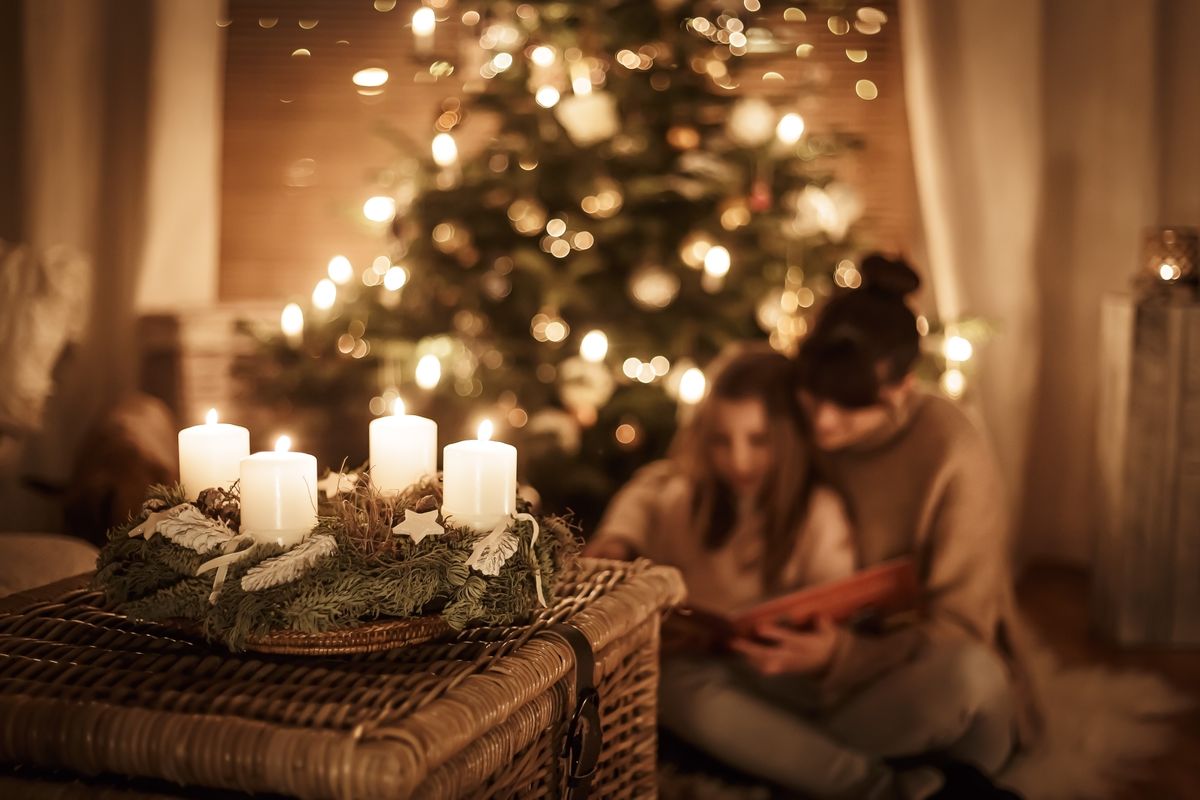Child,Sits,With,Mother,In,Front,Of,The,Christmas,Tree