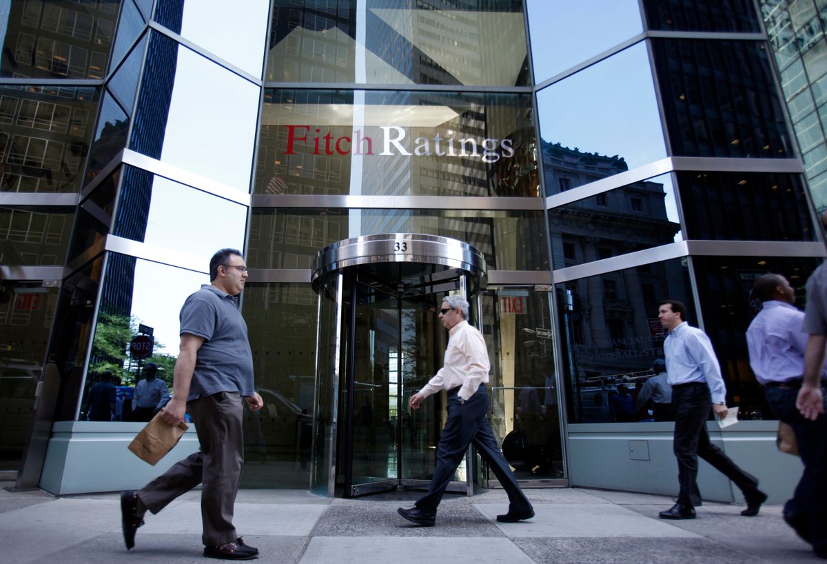 People walk in front of the Fitch Ratings building in New York