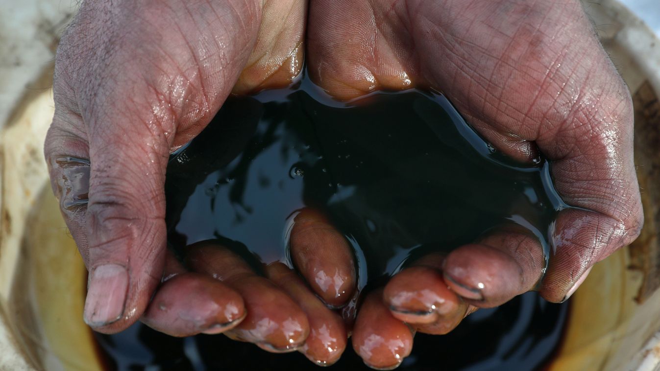 An employee demonstrates a sample of crude oil in the Irkutsk Oil Company-owned Yarakta Oil Field in Irkutsk Region